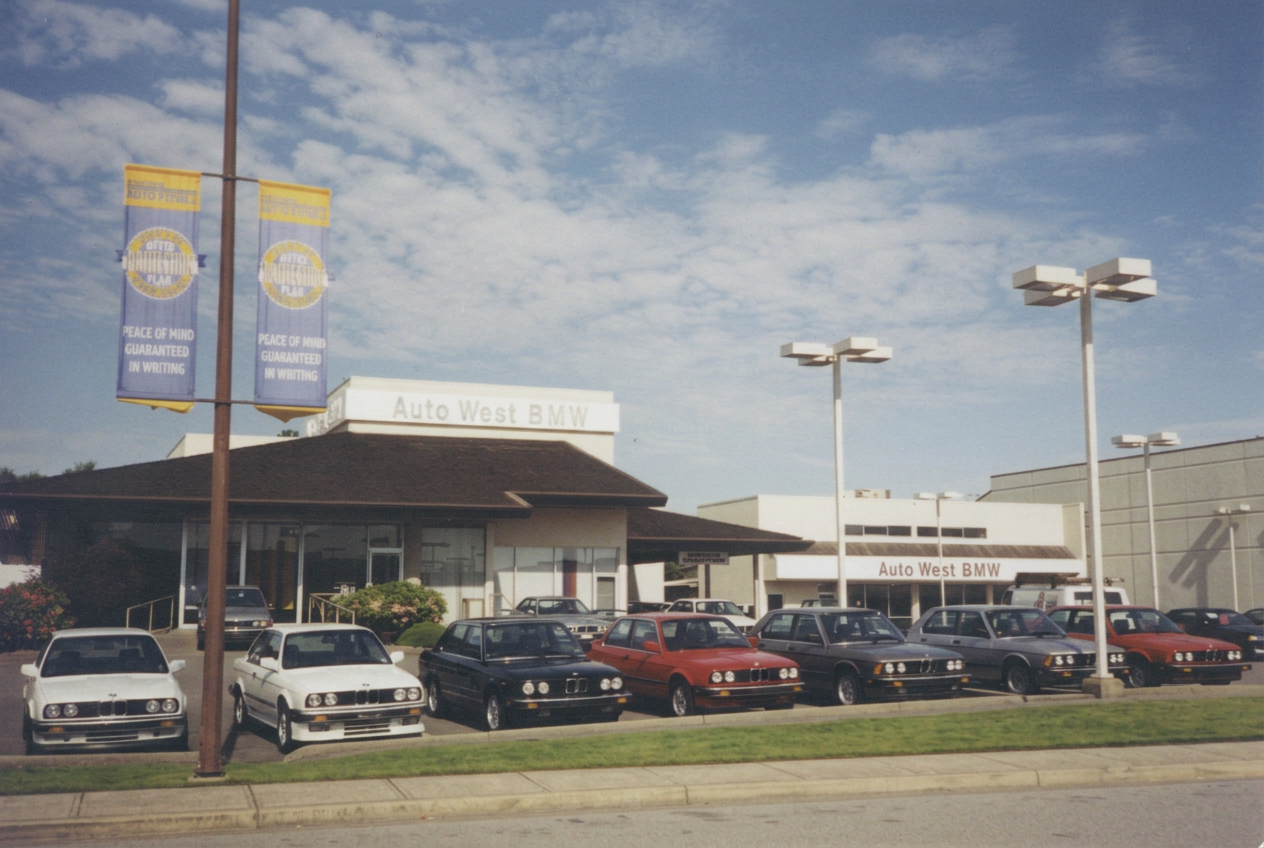 Auto West BMW dealership in 1986 with a lineup of BMW E30 and E28 models